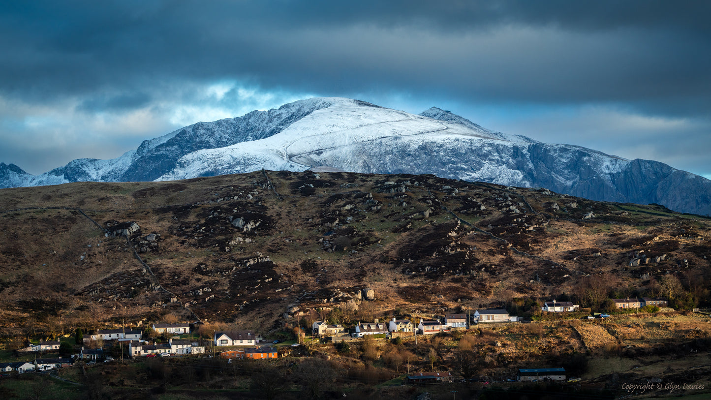 Snowdon Yr Wyddfa and Deiniolen in the Welsh Mountains of Snowdonia Eryri in winter with snow cap